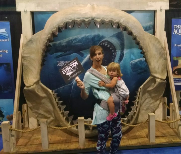 Sarah, 22 weeks pregnant, baby wearing toddler Ella at SharkCon.